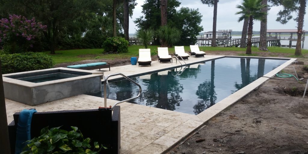 20150803_151232 16x40 rectangle swimming pool with a raised spillover spa with a travertine swimming pool deck surface and matching coping stones